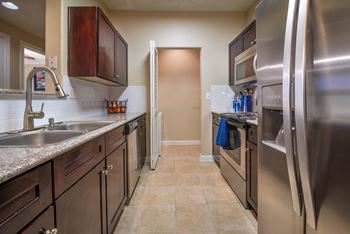 a kitchen with stainless steel appliances and granite counter tops